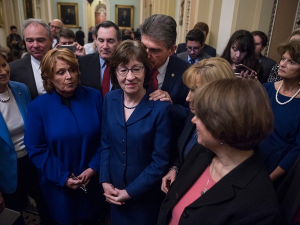 UNITED STATES - JANUARY 22: A bipartisan group of Senators hold a new conference in the Capitol after they voted to end debate on a continuing resolution to reopen the government on January 22, 2018. Appearing are, from left, Sens. Jeanne Shaheen, D-N.H., Tim Kaine, D-Va., Heidi Heitkamp, D-N.D., Joe Donnelly, D-Ind., Susan Collins, R-Maine, Joe Manchin, D-W.Va., Maggie Hassan, D-N.H., Amy Klobuchar, D-Minn., and Lisa Murkowski, R-Alaska. (Photo By Tom Williams/CQ Roll Call)