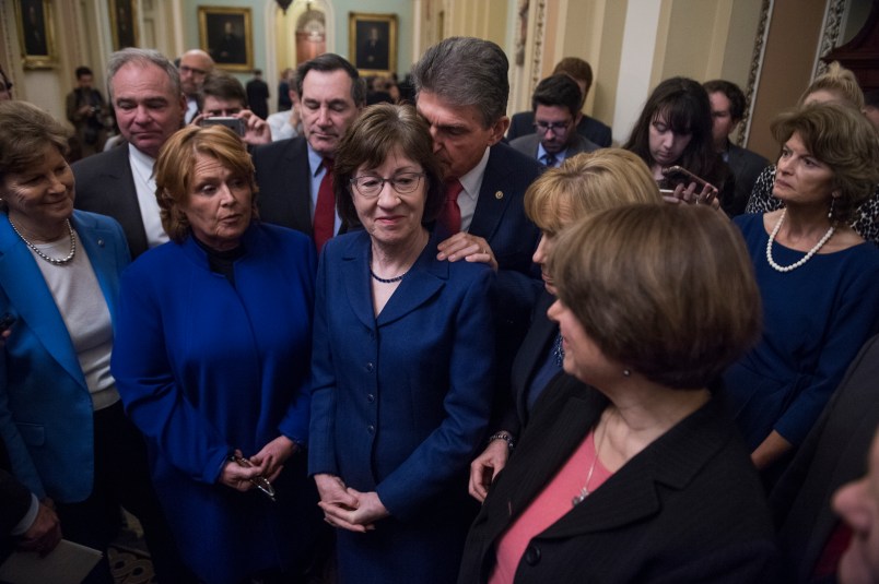 UNITED STATES - JANUARY 22: A bipartisan group of Senators hold a new conference in the Capitol after they voted to end debate on a continuing resolution to reopen the government on January 22, 2018. Appearing are, from left, Sens. Jeanne Shaheen, D-N.H., Tim Kaine, D-Va., Heidi Heitkamp, D-N.D., Joe Donnelly, D-Ind., Susan Collins, R-Maine, Joe Manchin, D-W.Va., Maggie Hassan, D-N.H., Amy Klobuchar, D-Minn., and Lisa Murkowski, R-Alaska. (Photo By Tom Williams/CQ Roll Call)