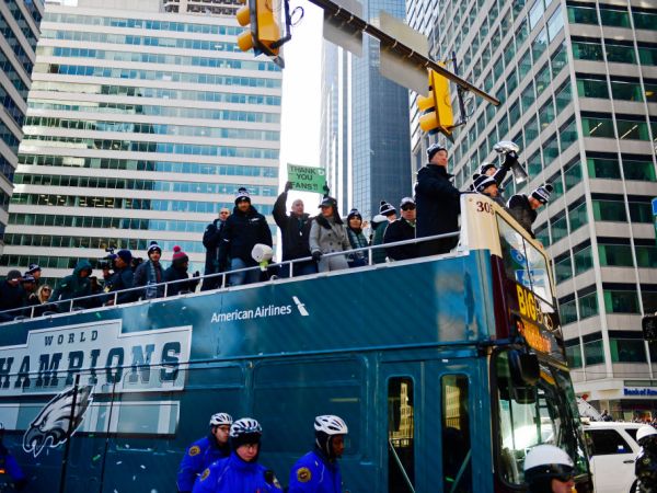 PHILADELPHIA, PA - FEBRUARY 08: (L-R) Team owner Jeffrey Lurie, with quarterbacks Nick Foles #9, Nate Sudfeld #7 and Carson Wentz #11 of the Philadelphia Eagles, acknowledge fans as Sudfeld hoists the Vince Lombardi Trophy atop a parade bus during festivities on February 8, 2018 in Philadelphia, Pennsylvania. The city celebrated the Philadelphia Eagles' Super Bowl LII championship with a victory parade. (Photo by Corey Perrine/Getty Images)