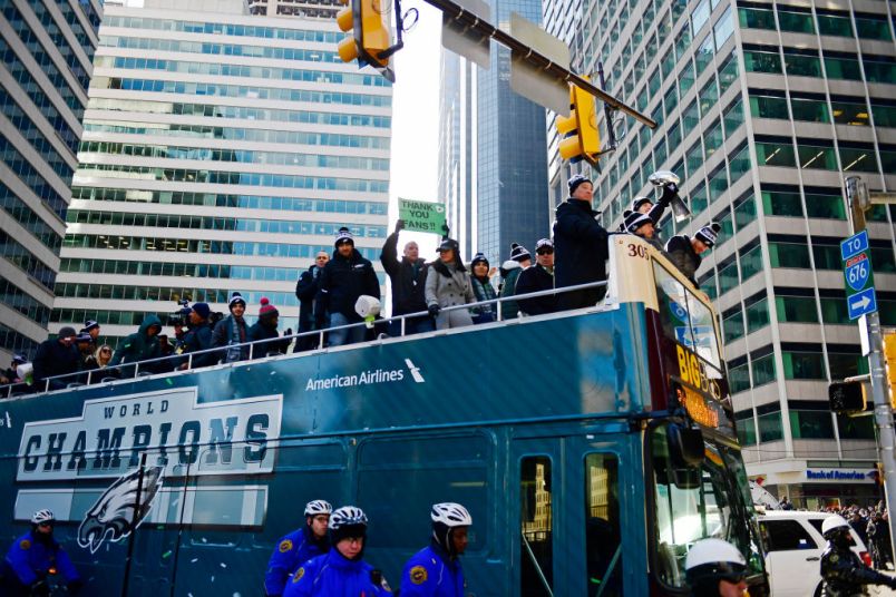 PHILADELPHIA, PA - FEBRUARY 08: (L-R) Team owner Jeffrey Lurie, with quarterbacks Nick Foles #9, Nate Sudfeld #7 and Carson Wentz #11 of the Philadelphia Eagles, acknowledge fans as Sudfeld hoists the Vince Lombardi Trophy atop a parade bus during festivities on February 8, 2018 in Philadelphia, Pennsylvania. The city celebrated the Philadelphia Eagles' Super Bowl LII championship with a victory parade. (Photo by Corey Perrine/Getty Images)