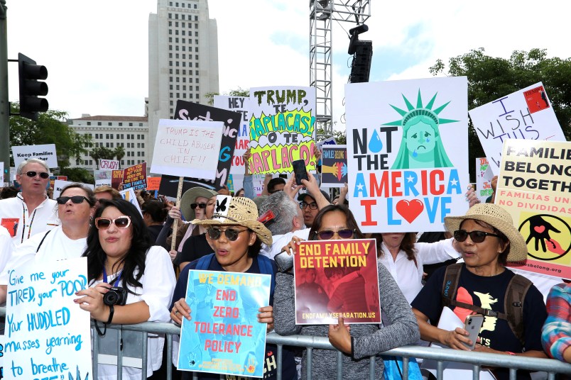 People hold signs as they participate in the "Families Belong Together: Freedom for Immigrants" march on Saturday, June 30, 2018, in Los Angeles. In major cities and tiny towns, marchers gathered across America, moved by accounts of children separated from their parents at the U.S.-Mexico border, in the latest act of mass resistance against President Donald Trump's immigration policies.(Photo by Willy Sanjuan/Invision/AP)
