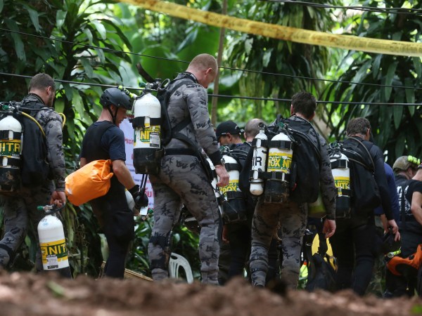 International rescuers team prepare walk in of a cave where a young soccer team and their coach are believed to be missing, Thursday, July 5, 2018, in Mae Sai, Chiang Rai province, in northern Thailand. With more rain coming, Thai rescuers are racing against time to pump out water from a flooded cave before they can extract 12 boys and their soccer coach with minimum risk, officials said Thursday. (AP Photo/Sakchai Lalit)