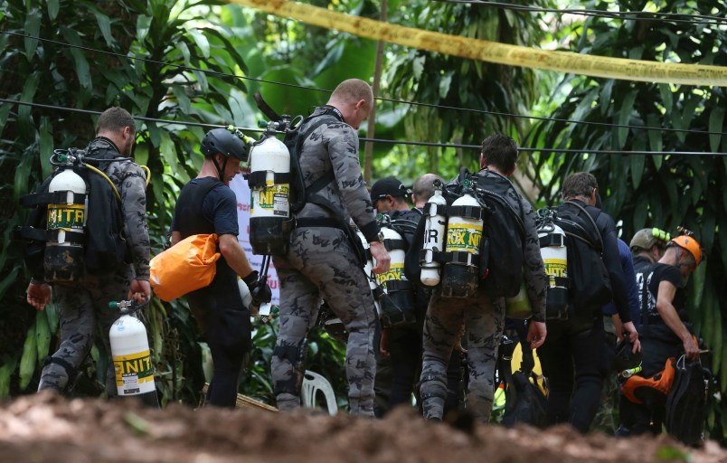 International rescuers team prepare walk in of a cave where a young soccer team and their coach are believed to be missing, Thursday, July 5, 2018, in Mae Sai, Chiang Rai province, in northern Thailand. With more rain coming, Thai rescuers are racing against time to pump out water from a flooded cave before they can extract 12 boys and their soccer coach with minimum risk, officials said Thursday. (AP Photo/Sakchai Lalit)