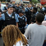 Members of the Chicago police department and an angry crowd, at the scene of a police involved shooting in the 7100 block of South Chappel Ave., in Chicago, on Saturday July 14, 2018.(Nuccio DiNuzzo/Chicago Tribune)