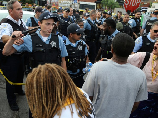 Members of the Chicago police department and an angry crowd, at the scene of a police involved shooting in the 7100 block of South Chappel Ave., in Chicago, on Saturday July 14, 2018.(Nuccio DiNuzzo/Chicago Tribune)