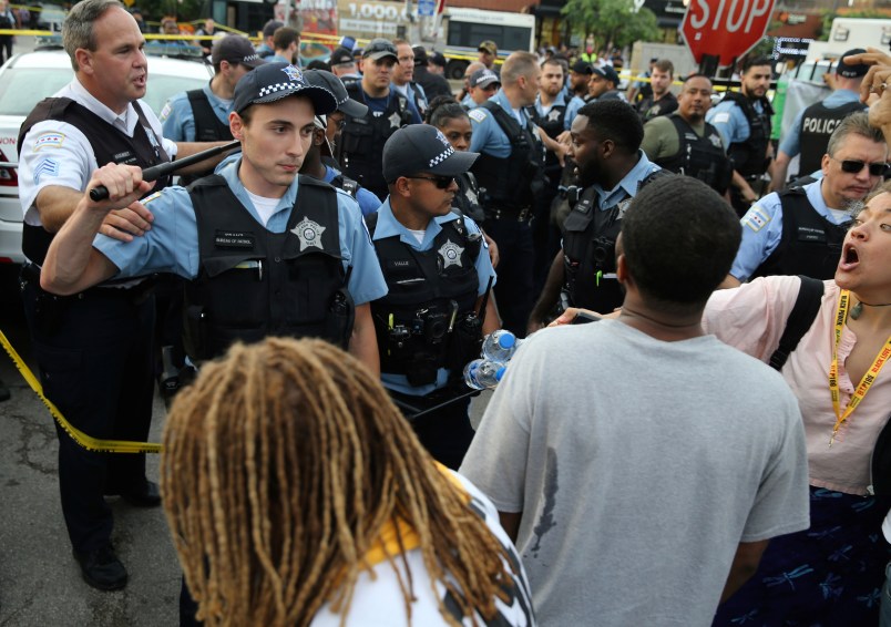 Members of the Chicago police department and an angry crowd, at the scene of a police involved shooting in the 7100 block of South Chappel Ave., in Chicago, on Saturday July 14, 2018.(Nuccio DiNuzzo/Chicago Tribune)