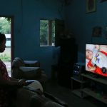 In this July 18, 2018 photo Adalicia Montecinos watches a video at her home, in La Libertad, Honduras of her son Johan Bueso Castillo who was separated from his father at the Texas border. Montecinos watches videos of her infant son Johan over and over again. She had recorded each month of his life before he left for the United States with his father. (AP Photo/Esteban Felix)
