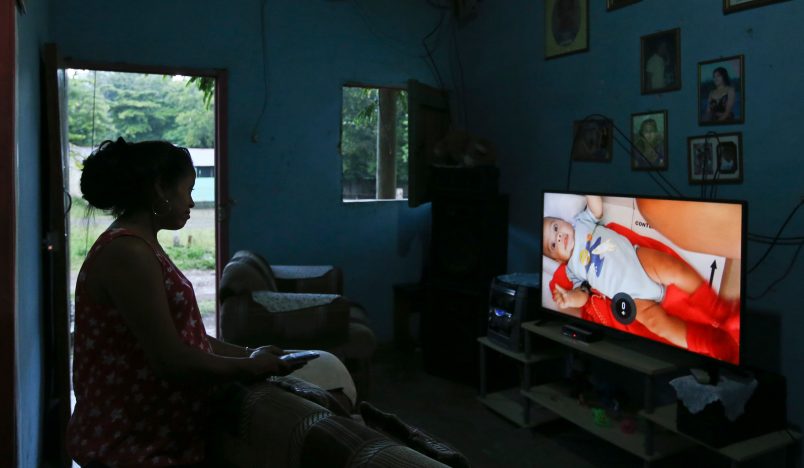 In this July 18, 2018 photo Adalicia Montecinos watches a video at her home, in La Libertad, Honduras of her son Johan Bueso Castillo who was separated from his father at the Texas border. Montecinos watches videos of her infant son Johan over and over again. She had recorded each month of his life before he left for the United States with his father. (AP Photo/Esteban Felix)