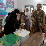 A Pakistani woman casts her vote at a polling station for the parliamentary elections in Rawalpindi, Pakistan, Wednesday, July 25, 2018. After an acrimonious campaign, polls opened in Pakistan on Wednesday to elect the country's third straight civilian election, a first for this majority Muslim nation that has been directly or indirectly ruled by its military for most of its 71-year history. (AP Photo/B.K. Bangash)