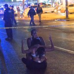 People react at the scene of the 3400 block of South Claiborne Street where two people are dead and seven more injured in a shooting in New Orleans, La. Saturday, July 28, 2018. (AP Photo/The New Orleans Advocate,Matthew Hinton)