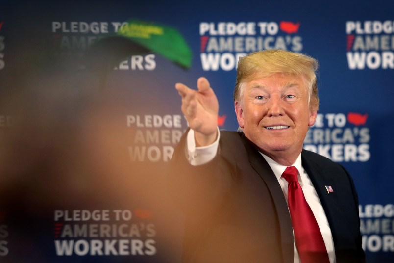 PEOSTA, IA - JULY 26:  President Donald Trump tosses a "Make Farmers Great Again" hat to guests following a roundtable discussion at Northeast Iowa Community College on July 26, 2018 in Peosta, Iowa. The stop is the first of two Midwest stops the president has scheduled for today. Later this afternoon Trump will visit U.S. Steel’s Granite City Works near St. Louis.  (Photo by Scott Olson/Getty Images)