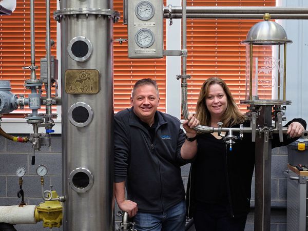 Afton, VA -  February 6:  Denver Riggleman and his wife Christine Riggleman stand by one of the stills at the Silverback Distillery they own in Afton, Va. Saturday, February 6, 2016.  They believe that the laws governing distilleries in Virginia are biased towards wineries and breweries which have a larger lobby and presence in the state.  (Photo by Norm Shafer/ For The Washington Post).