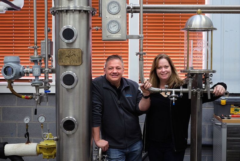 Afton, VA -  February 6:  Denver Riggleman and his wife Christine Riggleman stand by one of the stills at the Silverback Distillery they own in Afton, Va. Saturday, February 6, 2016.  They believe that the laws governing distilleries in Virginia are biased towards wineries and breweries which have a larger lobby and presence in the state.  (Photo by Norm Shafer/ For The Washington Post).