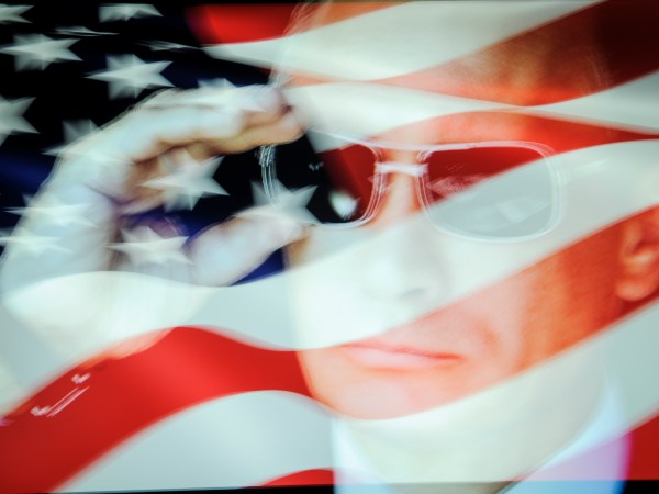 An American flag is seen with a portrait of Russian president Vladimir Putin in this photo illustration on October 31, 2017. Material posted on Facebok and other social media directly and indirectly reached over 126 million Americans between 2015 and 2017 according to a company testimony that will be presented to the US Senate judiciary committe on Tuesday. (Photo by Jaap Arriens/NurPhoto)