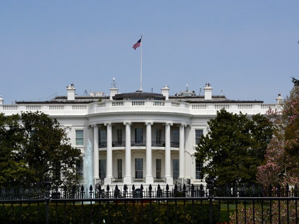 WASHINGTON, D.C. - APRIL 22, 2018:  An American flag flies over the south facade of the White House in Washington, D.C. Additional security fences and barriers were added along the south perimeter to prevent people from jumping the fence and entering the restricted White House grounds. The Secret Service tightened the security on the south side in 2017 by closing access to the entire fence line on the South Lawn. (Photo by Robert Alexander/Getty Images)