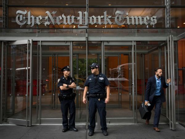 NEW YORK, NY - JUNE 28: Members of the New York City Police Department stand outside the headquarters of The New York Times, June 28, 2018 in New York City. NYPD announced increased security in Manhattan at major media companies following a shooting today at the Capital Gazette newspaper in Maryland. (Photo by Drew Angerer/Getty Images)