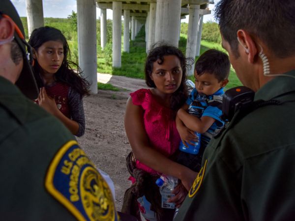 MISSION, TX - JUNE 27:Families from Guatemala are detained by United States Border Patrol agents for illegally crossing the U.S.-Mexico border along the Rio Grande on Wednesday, June 27, 2018, in Mission, TX. They ended up directly underneath a legal port of entry – Anzalduas International Bridge.(Photo by Jahi Chikwendiu/The Washington Post)