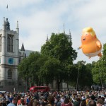 LONDON, UNITED KINGDOM - JULY 13: A 20-feet tall "Trump Baby" baloon depicting the US president as an angry orange infant with a smartphone, flies above Parliament Square in central London. Donald Trump and first lady Melania are due to meet the Queen today as part of their three-day working visit to the UK. July 13, 2018 in London, England.