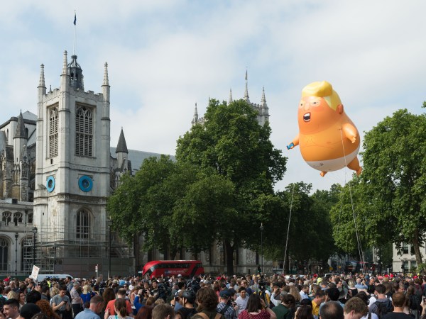 LONDON, UNITED KINGDOM - JULY 13: A 20-feet tall "Trump Baby" baloon depicting the US president as an angry orange infant with a smartphone, flies above Parliament Square in central London. Donald Trump and first lady Melania are due to meet the Queen today as part of their three-day working visit to the UK. July 13, 2018 in London, England.