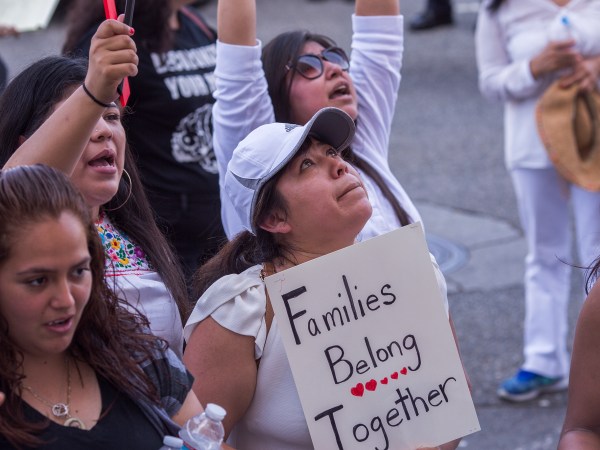 LOS ANGELES, CA - JUNE 30: People demonstrate and call out words of encouragement to immigrants held inside the Metropolitan Detention Center after marching to decry aggressive Trump administration immigration and refugee policies on June 30, 2018 in Los Angeles, California. Although President Trump was forced to reverse his policy of removing all children from their immigrant or asylum-seeking parents, little clarity appears to be seen as to how agencies can fulfill a court order to reunite thousands of children and parents detained far apart by multiple agencies. Yesterday, the Justice Department filed papers in a Los Angeles federal court to have families arrested for illegal border crossings incarcerated together indefinitely. The rally is one of more than 700 such protests being held throughout the nation.  (Photo by David McNew/Getty Images)