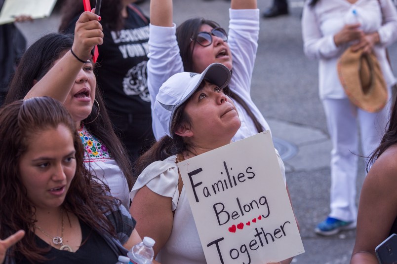 LOS ANGELES, CA - JUNE 30: People demonstrate and call out words of encouragement to immigrants held inside the Metropolitan Detention Center after marching to decry aggressive Trump administration immigration and refugee policies on June 30, 2018 in Los Angeles, California. Although President Trump was forced to reverse his policy of removing all children from their immigrant or asylum-seeking parents, little clarity appears to be seen as to how agencies can fulfill a court order to reunite thousands of children and parents detained far apart by multiple agencies. Yesterday, the Justice Department filed papers in a Los Angeles federal court to have families arrested for illegal border crossings incarcerated together indefinitely. The rally is one of more than 700 such protests being held throughout the nation.  (Photo by David McNew/Getty Images)