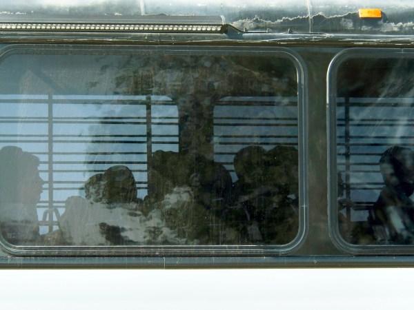 FILE - In this Firday, June 8, 2018 file photo, Department of Homeland Security buses with detained immigrants aboard enter the Federal Correctional Institution in Victorville, Calif., in the Mojave Desert Northeast of Los Angeles. Immigrants have sued the U.S. government over conditions at this facility to house immigration detainees since the Trump administration stepped up arrests on the U.S.-Mexico border. The lawsuit filed Wednesday, Aug. 1, 2018 in federal court in Riverside, Calif., alleges that prison conditions at the medium-security facility are too restrictive for immigrants detained while awaiting immigration court hearings. (James Quigg/The Daily Press via AP, File)