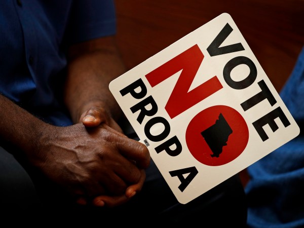 ** HOLD FOR USE WITH STORY BY DAVID LIEB ** In this photo taken Tuesday, July 31, 2018, people opposing Proposition A listen to a speaker during a rally in Kansas City, Mo. Missouri votes Tuesday on a so-called right-to-work law, a voter referendum seeking to ban compulsory union fees in all private-sector workplaces. (AP Photo/Charlie Riedel)