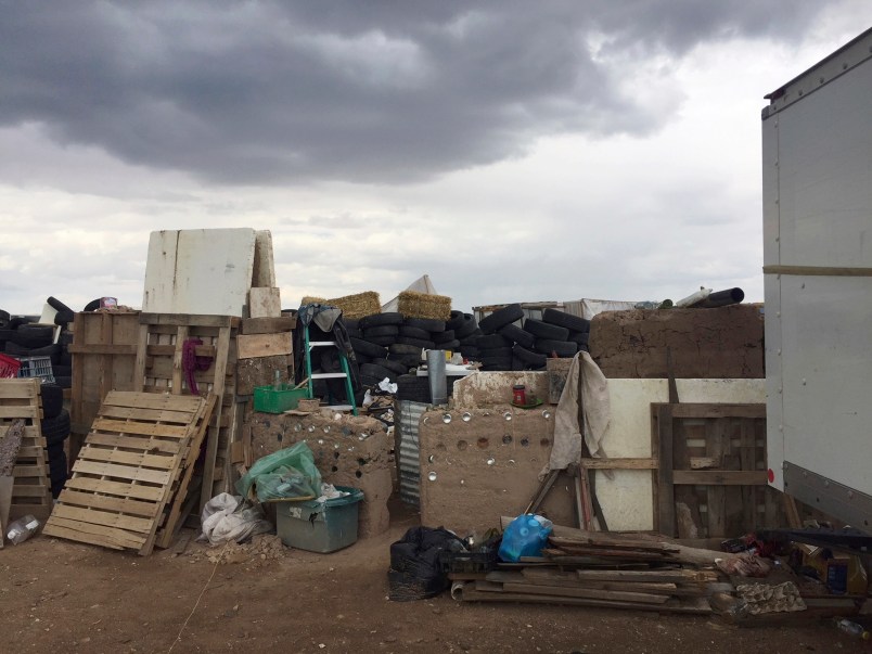 FILE - This Friday, Aug. 3, 2018, file photo released by Taos County Sheriff's Office shows a rural compound during an unsuccessful search for a missing 3-year-old boy in Amalia, N.M. Authorities say they've arrested three women believed to be the mothers of 11 children found living in filth in a makeshift compound in rural northern New Mexico. Taos County, New Mexico, Sheriff Jerry Hogrefe said Monday, Aug. 6, 2018, that the women and two men who were arrested over the weekend face charges of child abuse. (Taos County Sheriff's Office via AP,File)