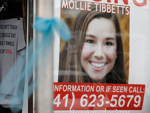 A poster for missing University of Iowa student Mollie Tibbetts hangs in the window of a local business, Tuesday, Aug. 21, 2018, in Brooklyn, Iowa. Tibbetts was reported missing from her hometown in the eastern Iowa city of Brooklyn in July 2018. (AP Photo/Charlie Neibergall)