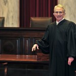 ADVANCE FOR SUNDAY JAN. 15 AND THEREAFTER- In this Thursday Jan. 5, 2012 photo West Virginia Supreme Court of Appeals Chief Justice Menis Ketchum poses in his robe in the court chambers in Charleston, W. Va. Menis Ketchum began a one-year rotation as chief justice on Jan. 1.  (AP Photo/Charleston Daily Mail, Bob Wojcieszak)