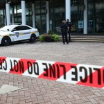 Jacksonville police officers guard an area Monday, Aug. 27, 2018, near the scene of  mass shooting at Jacksonville Landing in Jacksonville, Fla. A gunman opened fire Sunday at an online video game tournament  killing two people and then fatally shooting himself in a rampage that wounded several others. (AP Photo/John Raoux)