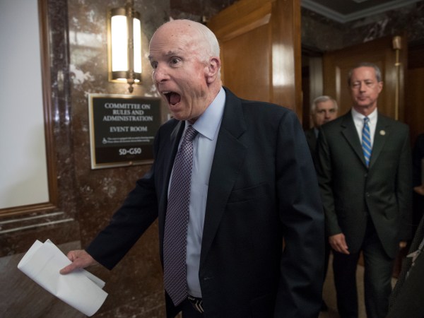Senate Armed Services Chairman John McCain, R-Ariz., followed at right by House Armed Services Chairman Mac Thornberry, R-Texas, makes a humorous face to reporters as he arrives to speak before a meeting of the National Defense Authorization Act conferees, on Capitol Hill in Washington, Wednesday, Oct. 25, 2017.  (AP Photo/J. Scott Applewhite)