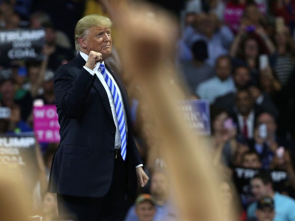 CHARLESTON, WV - AUGUST 21:  People cheer as President Donald Trump speaks at a rally on August 21, 2018 in Charleston, West Virginia. Paul Manafort, a former campaign manager for Donald Trump and a longtime political operative, was found guilty of eight financial crimes Tuesday in a Washington court. In further developments for the president, his former lawyer, Michael Cohen, has plead guilty in New York as part of a separate deal withÊprosecutors.  (Photo by Spencer Platt/Getty Images) *** Local Caption *** Donald Trump