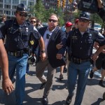 UNITED STATES - JULY 19: Radio host Alex Jones is escorted from a rally in the Public Square after inciting a confrontation near the Republican National Convention at the Quicken Loans Arena in Cleveland, Ohio, July 19, 2016. (Photo By Tom Williams/CQ Roll Call)