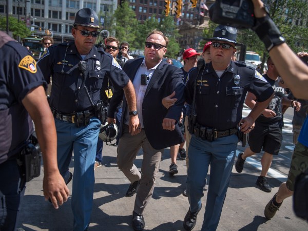 UNITED STATES - JULY 19: Radio host Alex Jones is escorted from a rally in the Public Square after inciting a confrontation near the Republican National Convention at the Quicken Loans Arena in Cleveland, Ohio, July 19, 2016. (Photo By Tom Williams/CQ Roll Call)