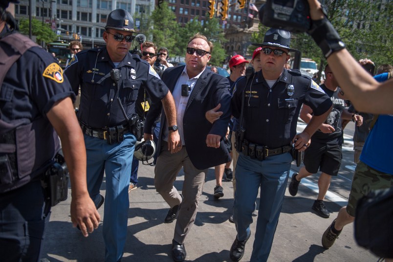UNITED STATES - JULY 19: Radio host Alex Jones is escorted from a rally in the Public Square after inciting a confrontation near the Republican National Convention at the Quicken Loans Arena in Cleveland, Ohio, July 19, 2016. (Photo By Tom Williams/CQ Roll Call)