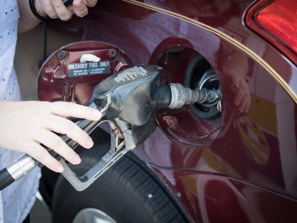 MIAMI, FLORIDA, UNITED STATES - 2017/04/28: Woman's hand holding a pump nozzle in car fuel tank door. She self serve gasoline in her main transportation vehicle. (Photo by Roberto Machado Noa/LightRocket via Getty Images)