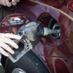 MIAMI, FLORIDA, UNITED STATES - 2017/04/28: Woman's hand holding a pump nozzle in car fuel tank door. She self serve gasoline in her main transportation vehicle. (Photo by Roberto Machado Noa/LightRocket via Getty Images)