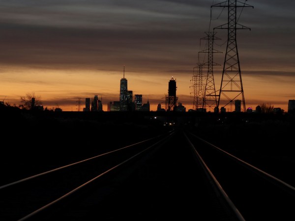 LYNDHURST, NJ - NOVEMBER 4: Train tracks lead to New York City as the sun rises behind lower Manhattan and One World Trade Center on November 4, 2017, as seen from Lyndhurst, New Jersey. (Photo by Gary Hershorn/Getty Images)