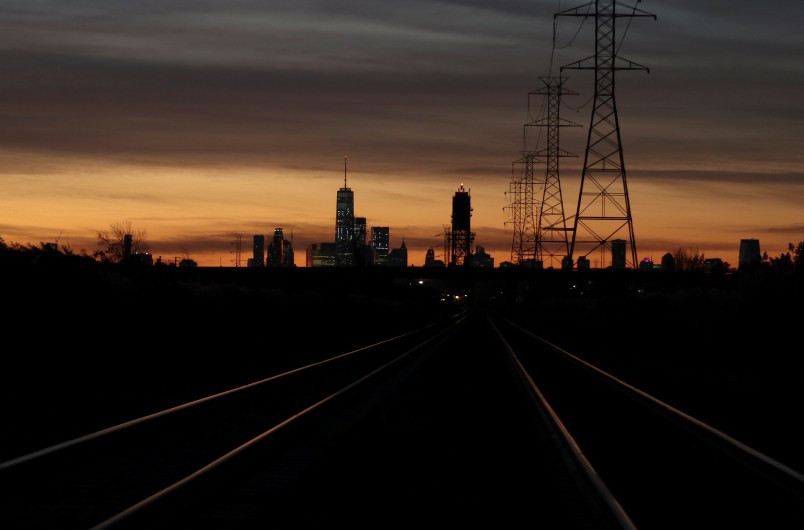 LYNDHURST, NJ - NOVEMBER 4: Train tracks lead to New York City as the sun rises behind lower Manhattan and One World Trade Center on November 4, 2017, as seen from Lyndhurst, New Jersey. (Photo by Gary Hershorn/Getty Images)