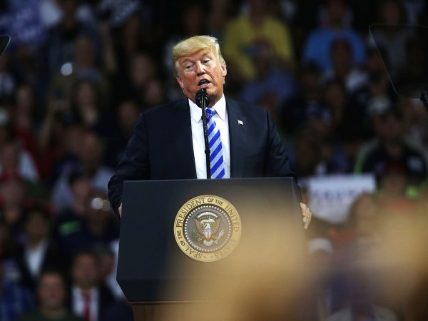 CHARLESTON, WV - AUGUST 21:  People cheer as President Donald Trump speaks at a rally on August 21, 2018 in Charleston, West Virginia. Paul Manafort, a former campaign manager for Donald Trump and a longtime political operative, was found guilty of eight financial crimes Tuesday in a Washington court. In further developments for the president, his former lawyer, Michael Cohen, has plead guilty in New York as part of a separate deal withÊprosecutors.  (Photo by Spencer Platt/Getty Images) *** Local Caption *** Donald Trump