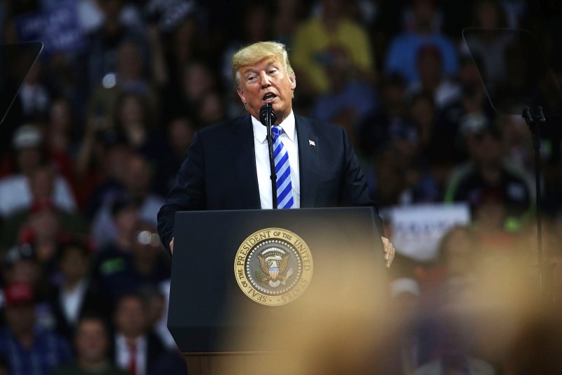 CHARLESTON, WV - AUGUST 21:  People cheer as President Donald Trump speaks at a rally on August 21, 2018 in Charleston, West Virginia. Paul Manafort, a former campaign manager for Donald Trump and a longtime political operative, was found guilty of eight financial crimes Tuesday in a Washington court. In further developments for the president, his former lawyer, Michael Cohen, has plead guilty in New York as part of a separate deal withÊprosecutors.  (Photo by Spencer Platt/Getty Images) *** Local Caption *** Donald Trump