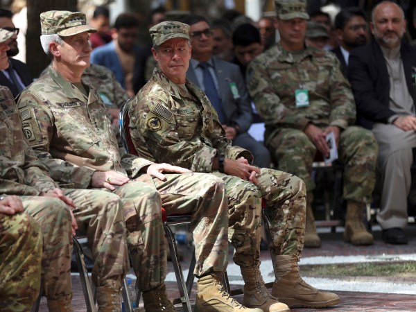 Outgoing U.S. Army Gen. John Nicholson, second left, listens as incoming U.S. Army Gen. Austin Miller, third left, looks at him, before the change of command ceremony starts, at Resolute Support headquarters, in Kabul, Afghanistan, Sunday, Sept. 2, 2018. U.S. Army Gen. Austin Miller has assumed command of the 41-nation NATO mission in Afghanistan following a handover ceremony. (AP Photo/Massoud Hossaini)