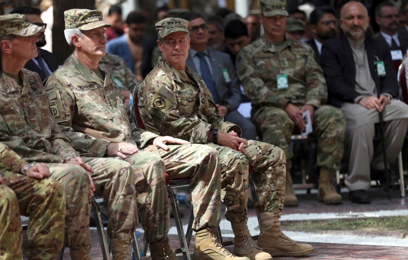 Outgoing U.S. Army Gen. John Nicholson, second left, listens as incoming U.S. Army Gen. Austin Miller, third left, looks at him, before the change of command ceremony starts, at Resolute Support headquarters, in Kabul, Afghanistan, Sunday, Sept. 2, 2018. U.S. Army Gen. Austin Miller has assumed command of the 41-nation NATO mission in Afghanistan following a handover ceremony. (AP Photo/Massoud Hossaini)