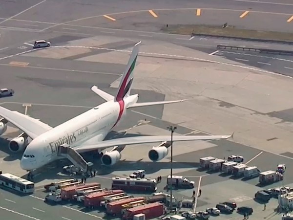 In this image made from video provided by WABC 7, emergency response crews gather outside a plane at JFK Airport after several passengers became sick on an Emirates flight from Dubai Wednesday, Sept. 5, 2018, in New York. (WABC 7 via AP)