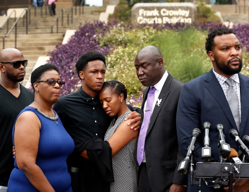 Brandt Jean, brother of shooting victim Botham Jean (third from left), hugs his sister Allisa Findley, during a press conference outside the Frank Crowley Courts Building in reference to the shooting of Jean by Dallas police officer Amber Guyger, Monday, September 10, 2018. He was joined by his mother, Allison Jean (left) and attorney Benjamin Crump (second from right). Their attorney Lee Merritt (right) speaks to the media. (Tom Fox/The Dallas Morning News)