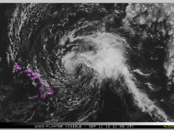 This satellite image from the National Oceanic and Atmospheric Administration (NOAA) shows Tropical Storm Olivia east of the main islands of Hawaii at around 10 a.m. Hawaii time Tuesday, Sept. 11, 2018. Olivia is dropping light rain on Maui and the Big Island as its outer rain bands approach the state. Central Pacific Hurricane Center meteorologist Matthew Foster says the storm could deposit 10 to 15 inches of rain on the islands, though some areas could get as much as 20 inches. Foster says it appears Maui County, the group of four islands just north of the Big Island, or Oahu will experience the worst effects. (NOAA via AP)