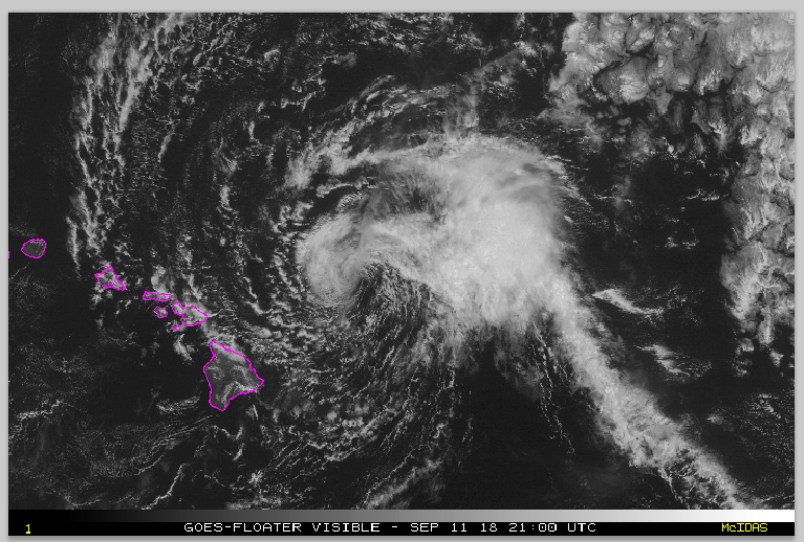 This satellite image from the National Oceanic and Atmospheric Administration (NOAA) shows Tropical Storm Olivia east of the main islands of Hawaii at around 10 a.m. Hawaii time Tuesday, Sept. 11, 2018. Olivia is dropping light rain on Maui and the Big Island as its outer rain bands approach the state. Central Pacific Hurricane Center meteorologist Matthew Foster says the storm could deposit 10 to 15 inches of rain on the islands, though some areas could get as much as 20 inches. Foster says it appears Maui County, the group of four islands just north of the Big Island, or Oahu will experience the worst effects. (NOAA via AP)