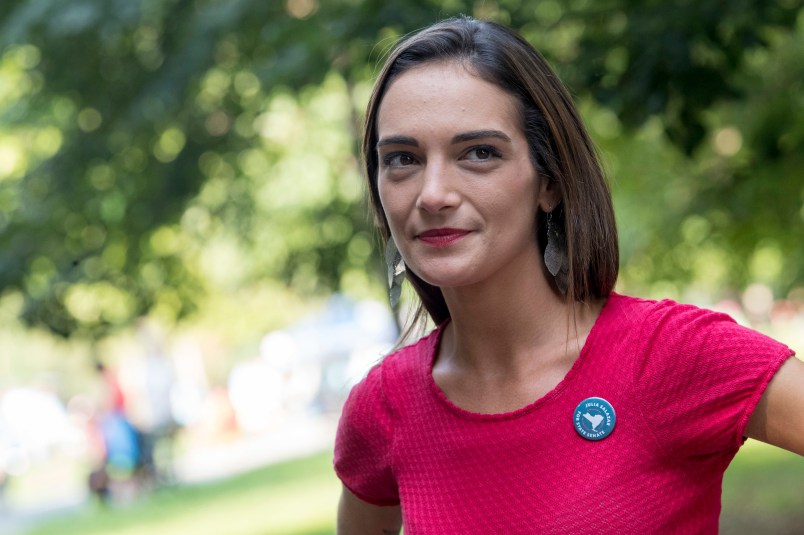 In this Wednesday, Aug. 15, 2018, photo, Democratic New York state Senate candidate Julia Salazar smiles as she speaks to a supporter before a rally in McCarren Park in the Brooklyn borough of New York. In a year in which establishment Democrats have found themselves stalked, and sometimes beaten, by more liberal challengers, Salazar seems well-positioned to become the next insurgent to knock off an incumbent. (AP Photo/Mary Altaffer)