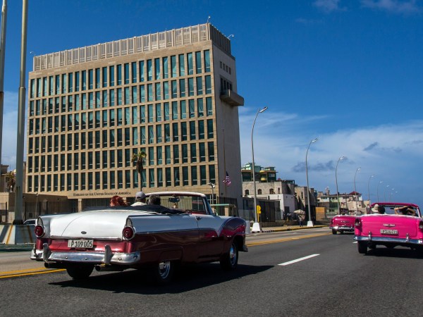 Tourists ride classic convertible cars on the Malecon beside the United States Embassy in Havana, Cuba, Tuesday, Oct. 3, 2017. Thousands of private Cuban businesses have invested heavily in private homes, cars and restaurants, hoping to cash in on an expected wave of American travelers to the island. Now that the U.S. State Department has issued a travel warning for the country, their investments are at risk.(AP Photo/Desmond Boylan)